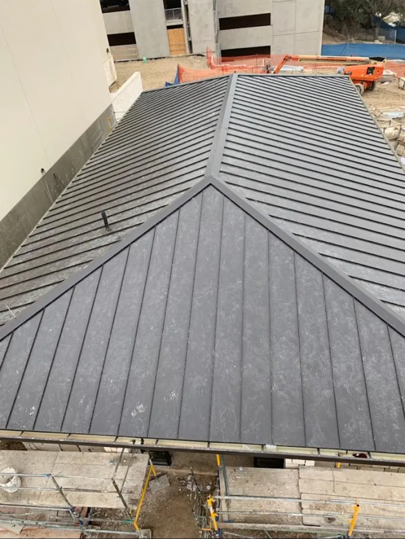 Commercial metal roof construction with crane equipment in Gages Lake